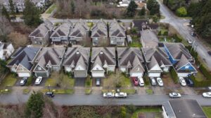 Aerial view of Shields Ave showing a row of identical homes with parked cars along the road.